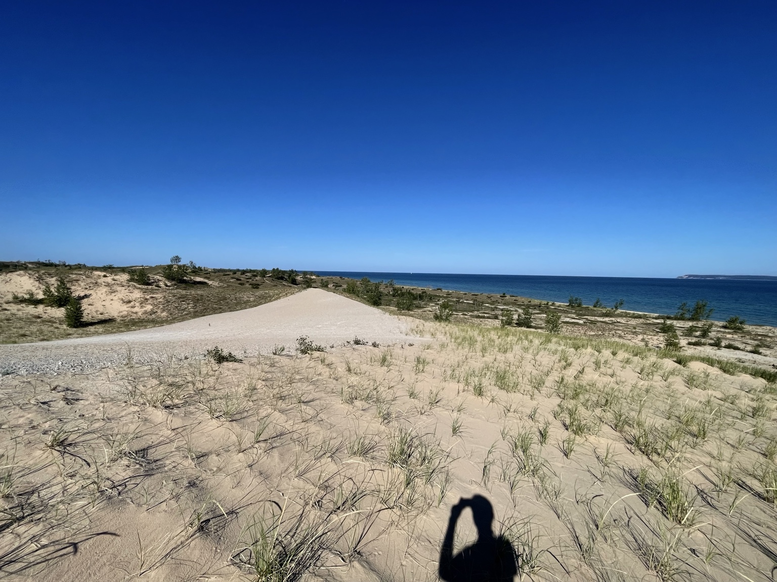 Dunes and Lake Michigan beneath an immense blue sky
